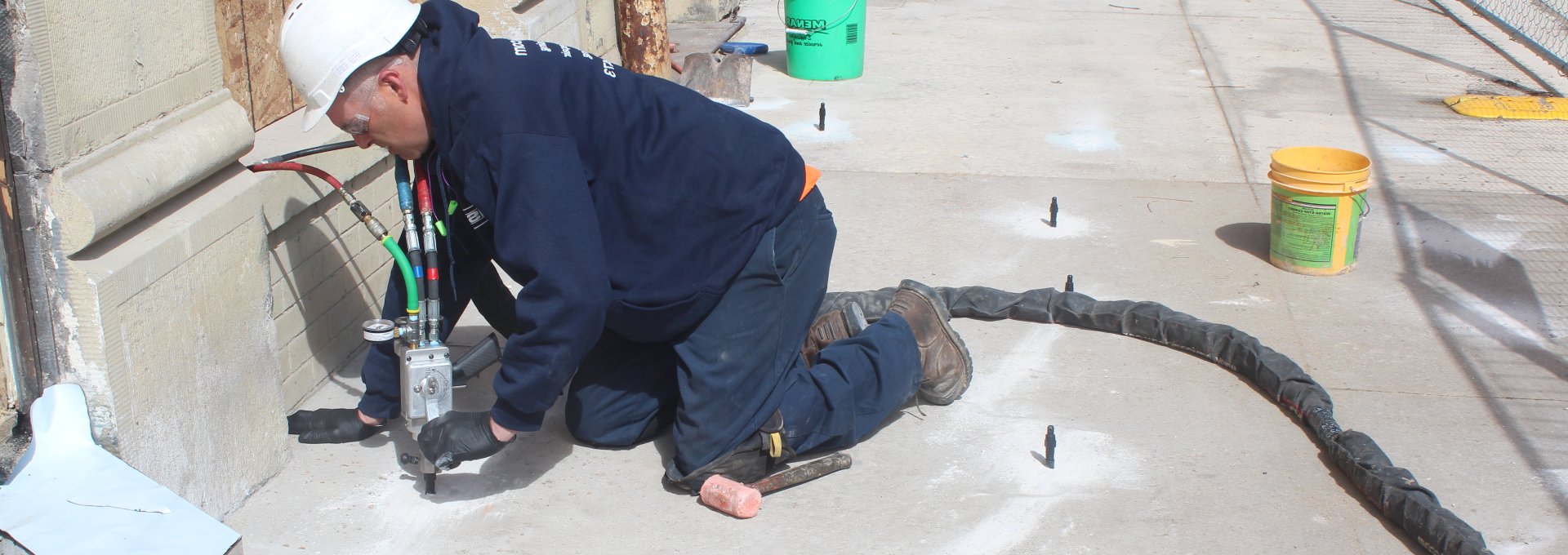 Man pumping foam into concrete slabs