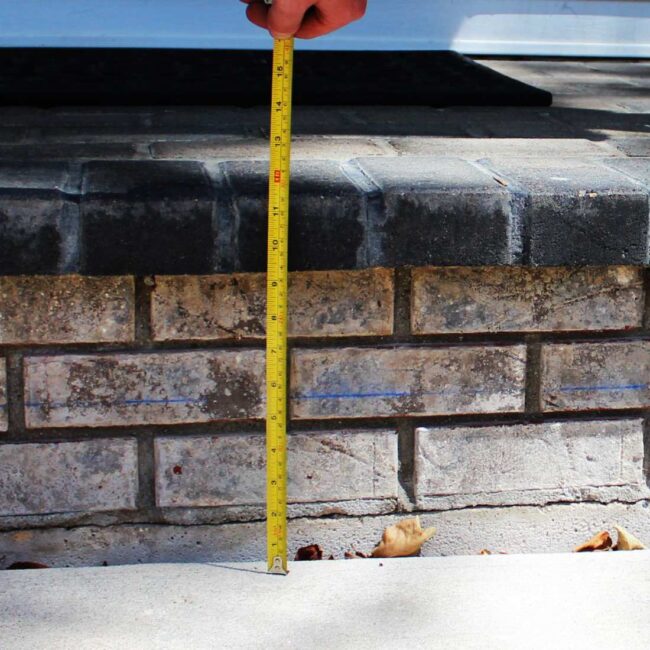 A measuring tape measuring a brick stair