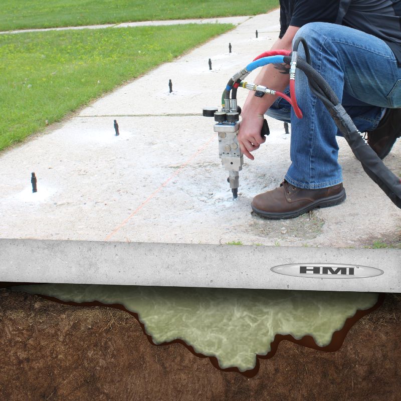 Man pumping polyurethane into the ground